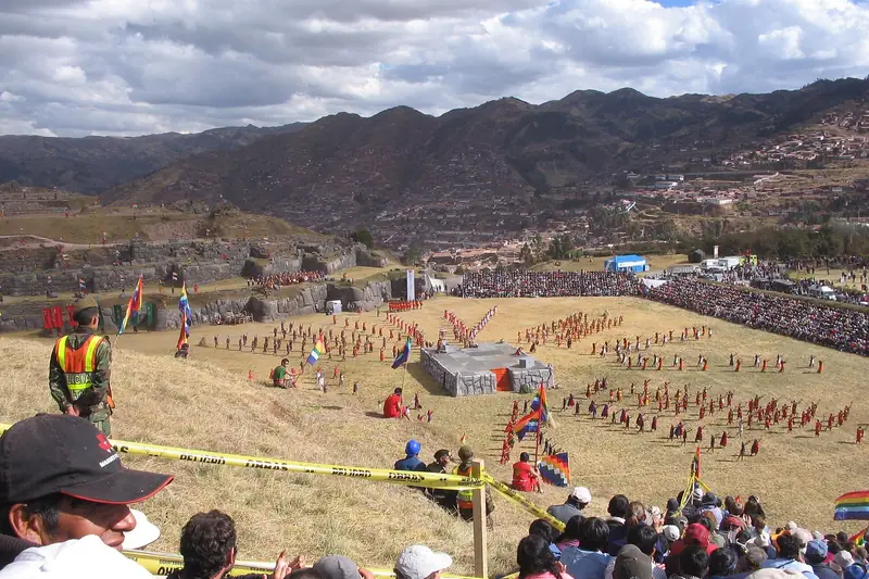 Inti Raymi re-enactment on the Sacsayhuamán esplanade in Cusco, with crowds on the slopes