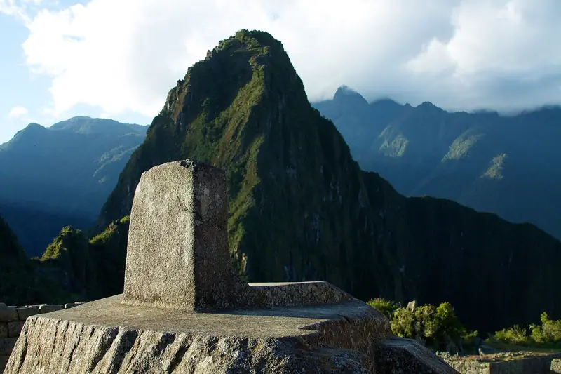 The Intihuatana stone at Machu Picchu with Huayna Picchu behind