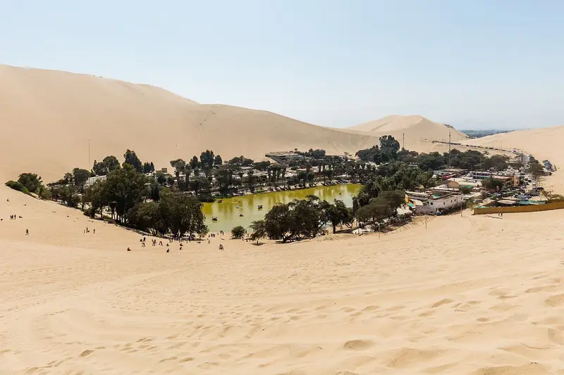 Huacachina oasis surrounded by tall dunes, Ica